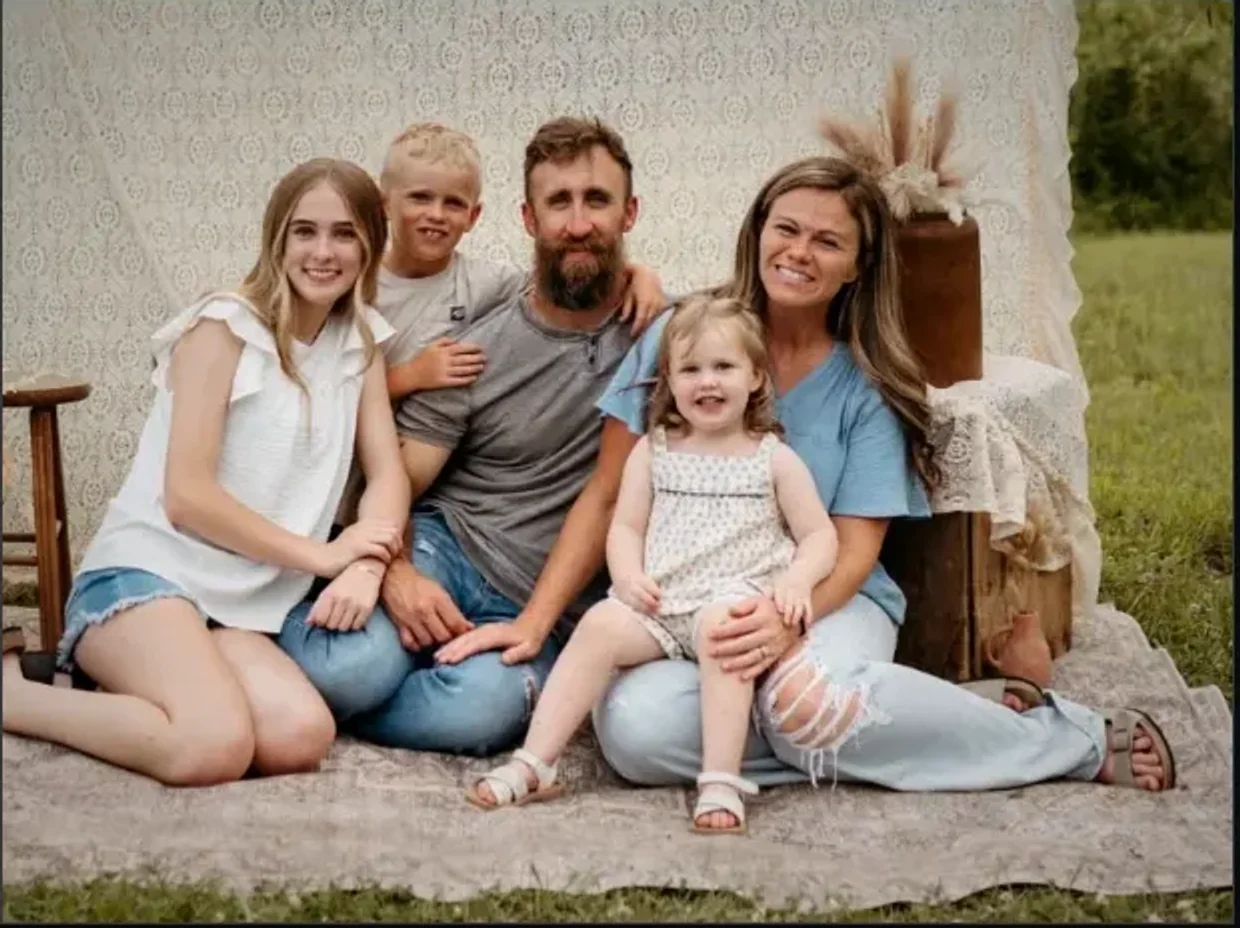 Brandon and Samantha seated with their three children at home in Muncie, Indiana