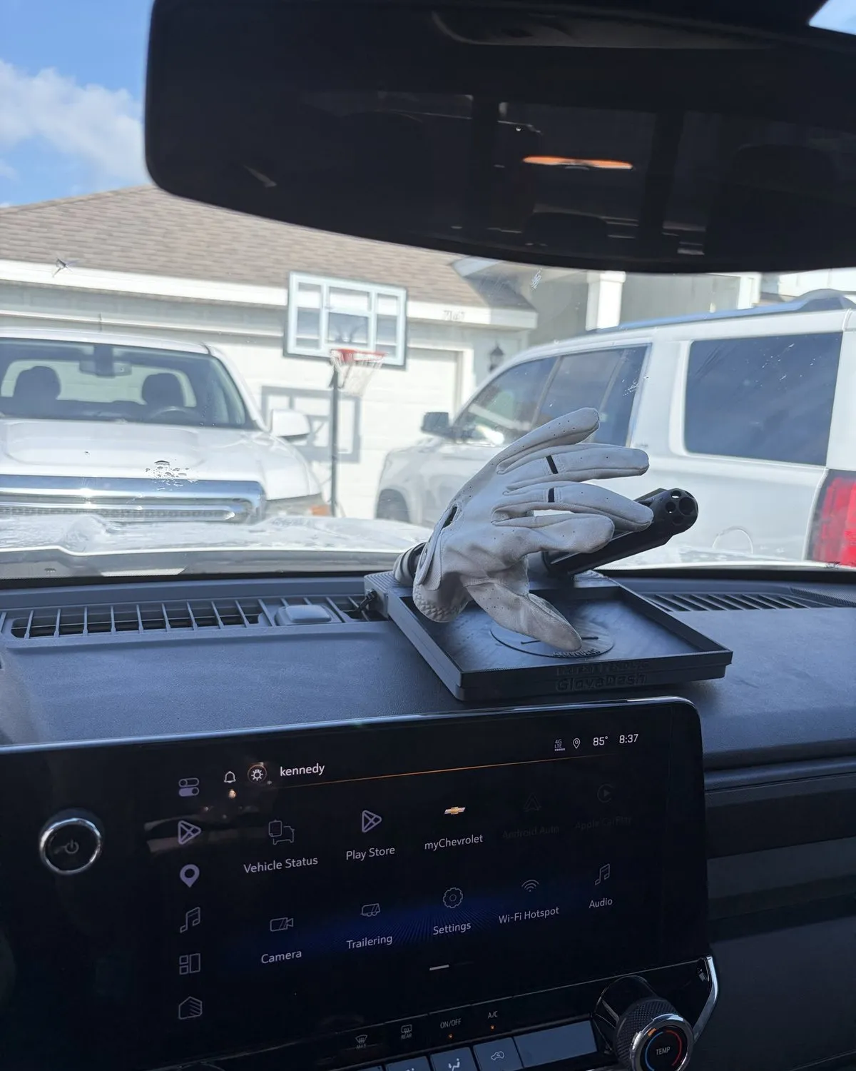 White work glove drying on a black GloveDash in a customer's truck