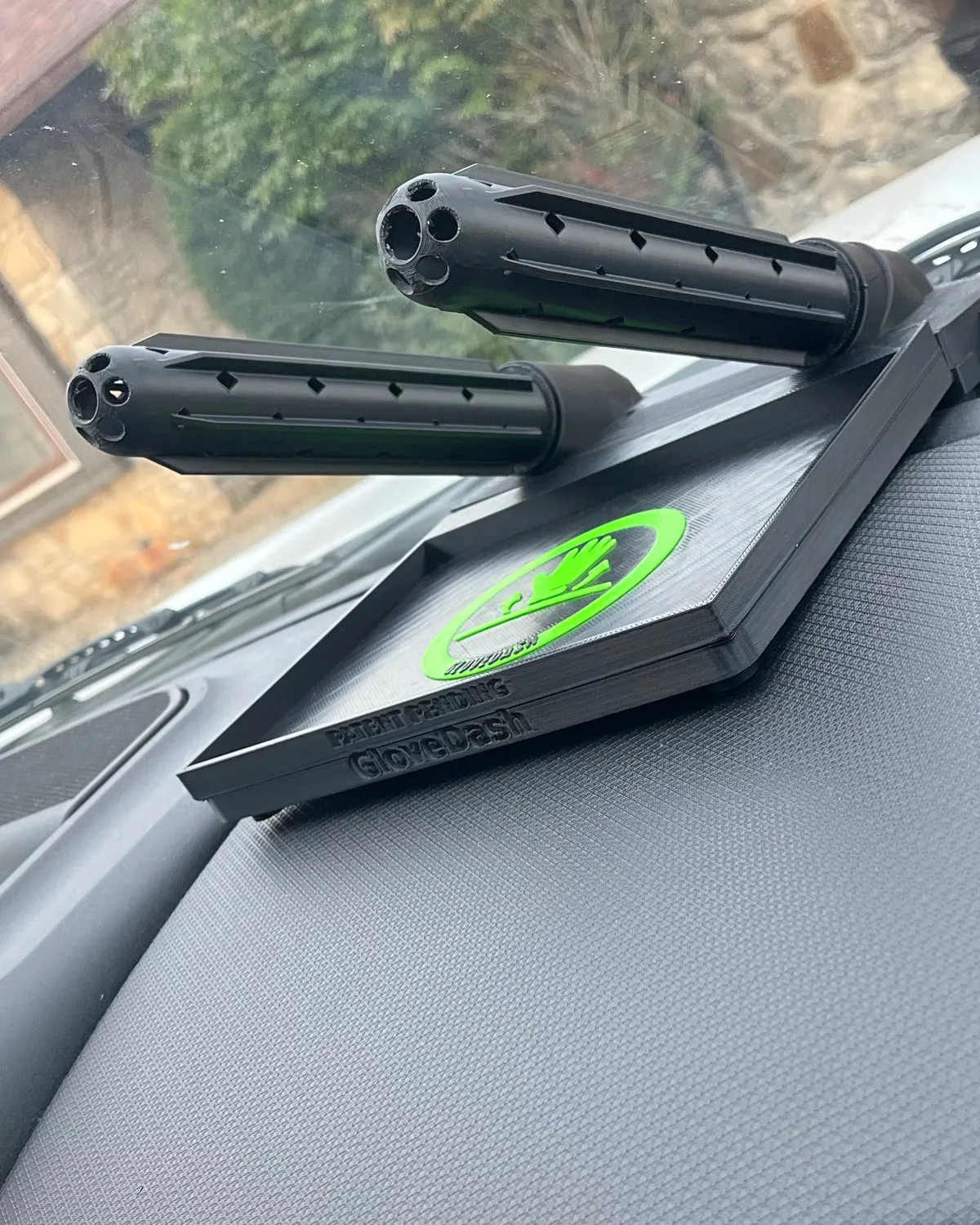Two black GloveDash tubes with vent slots and open hubs on a truck dashboard